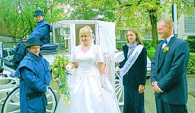 A bride and groom on their way to a traditional wedding