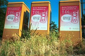 The old-fashioned yellow German telephone boxes